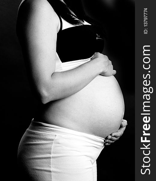 A shot of a beautiful pregnant woman in black and white