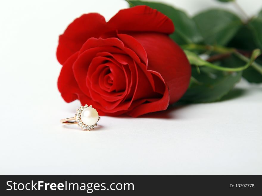 Ring with pearl and red rose on white