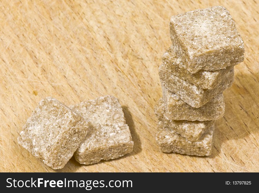 Square slices of brown sugar on a wooden table