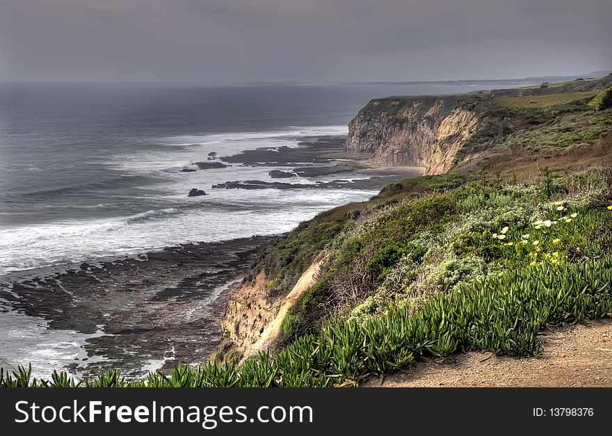 Sandstone cliffs plunge into the ocean in central california. Sandstone cliffs plunge into the ocean in central california