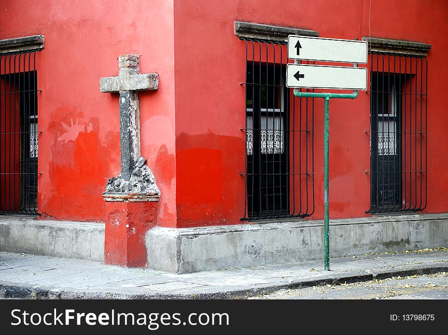 A corner  in a mexican street with a cross, windows and signs. A corner  in a mexican street with a cross, windows and signs.