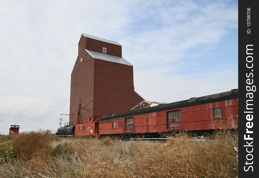 Old train by grain elevator