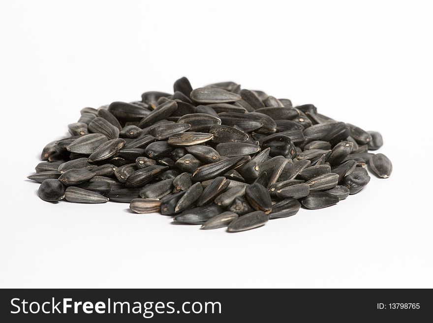 A handful of sunflower seeds, isolated on white