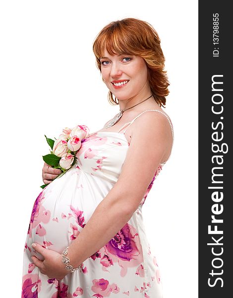 Pregnant woman wearing evening dress with bouquet of white roses