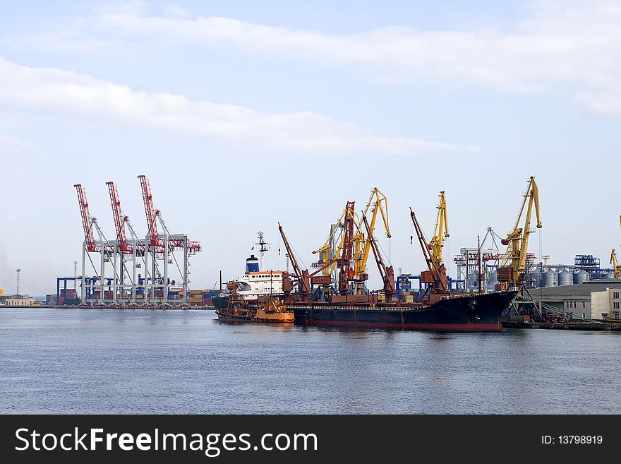 Port with cargo cranes and vessel