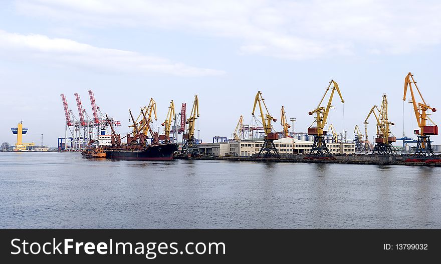 Panorama of the port with cargo cranes and vessel
