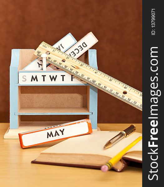 Month Blocks Desk Calendar with Books and Pen. Month Blocks Desk Calendar with Books and Pen