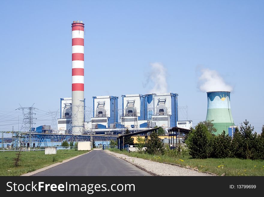 Cooling towers of power plant over blue sky with steam and co2 clouds. Cooling towers of power plant over blue sky with steam and co2 clouds