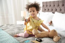 Free Cute African American Child Imagining Herself As Doctor While Playing With Stethoscope And Toy Bunny Royalty Free Stock Photography - 137945507