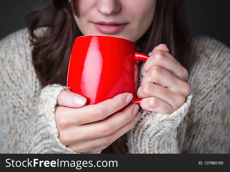 Girl In A Light Sweater Holding Red Cup Of Coffee