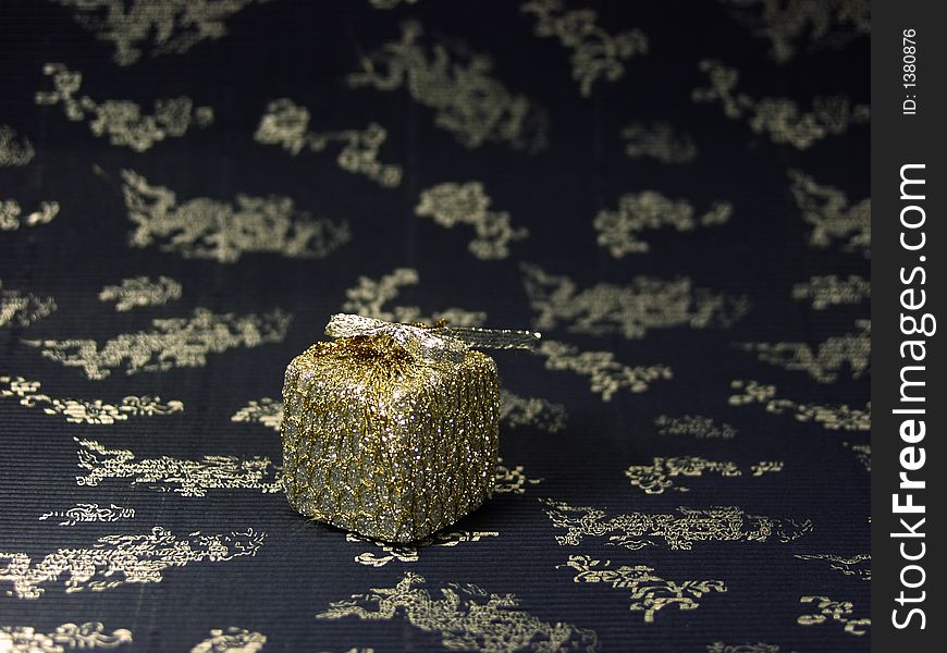 Close up of a silver christmas box on decorated background