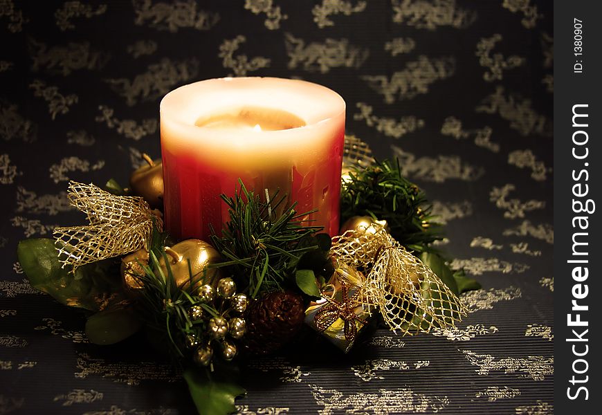 Christmas candle on decorated blue and silver background