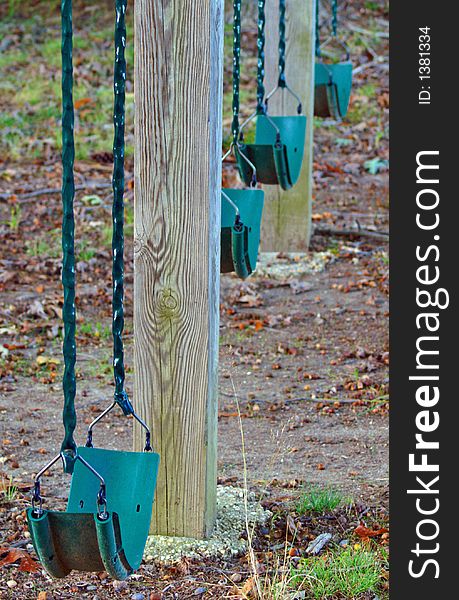 Four swings on wood playground equipment