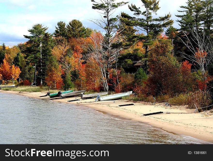 Boats on lake shore during Autumn time