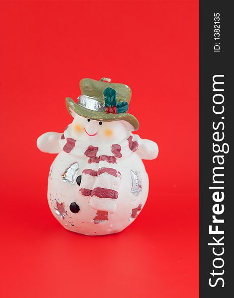 Isolated christmas decoration on red background (Snowman)