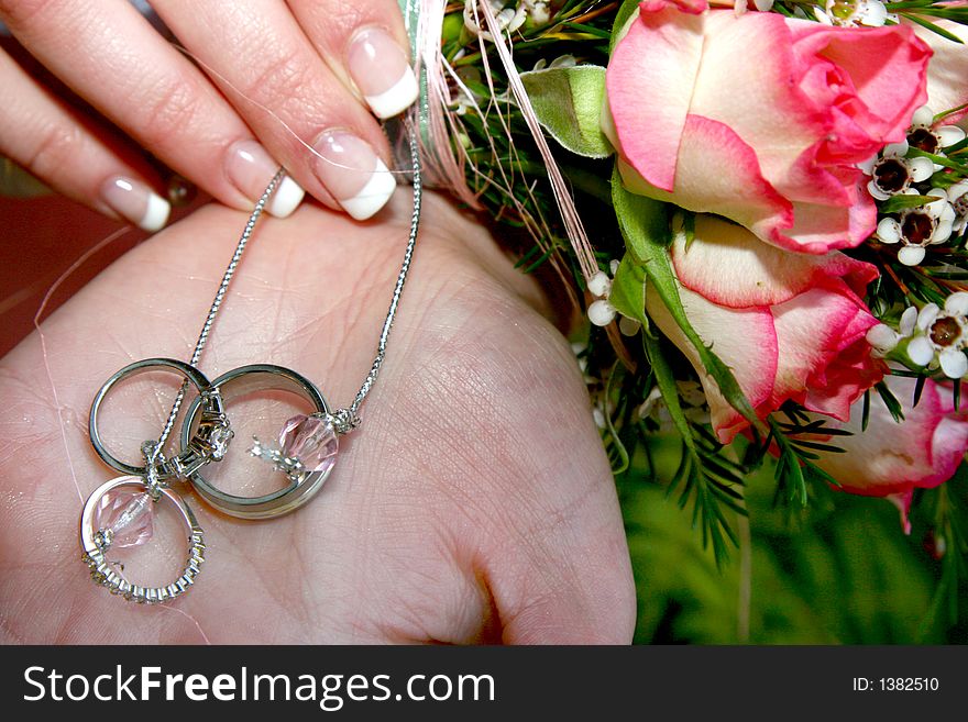 Wedding rings tied to a flower bouquet. Wedding rings tied to a flower bouquet