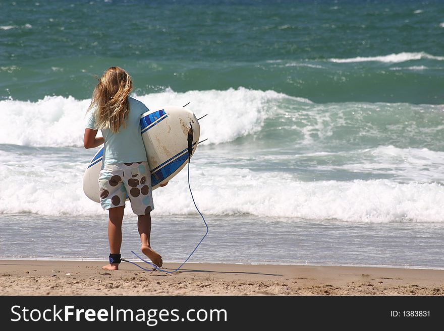 Young girl try to surf the ocean waves. Young girl try to surf the ocean waves