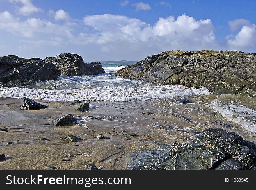 Seascape showing waves advancing through rocks just offshore in cornwall england on an autumn morning. Seascape showing waves advancing through rocks just offshore in cornwall england on an autumn morning
