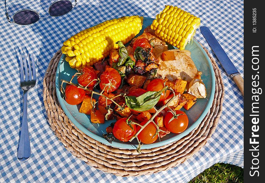 A healthy meal, consisting of corn, tomatoes, potatoes and some meat.