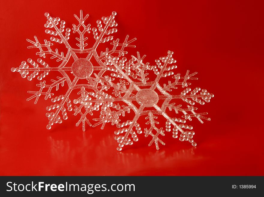 Glittery snowflake ornaments on a red background. Glittery snowflake ornaments on a red background