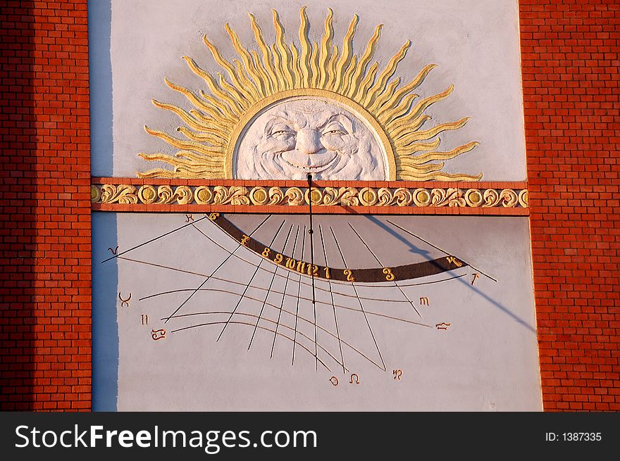 Sun clock (sun dial) on a wall of a building