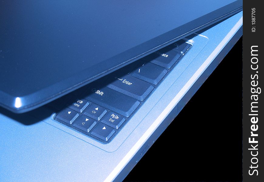 Blue shaded laptop in an opening mode. Blue shaded laptop in an opening mode.