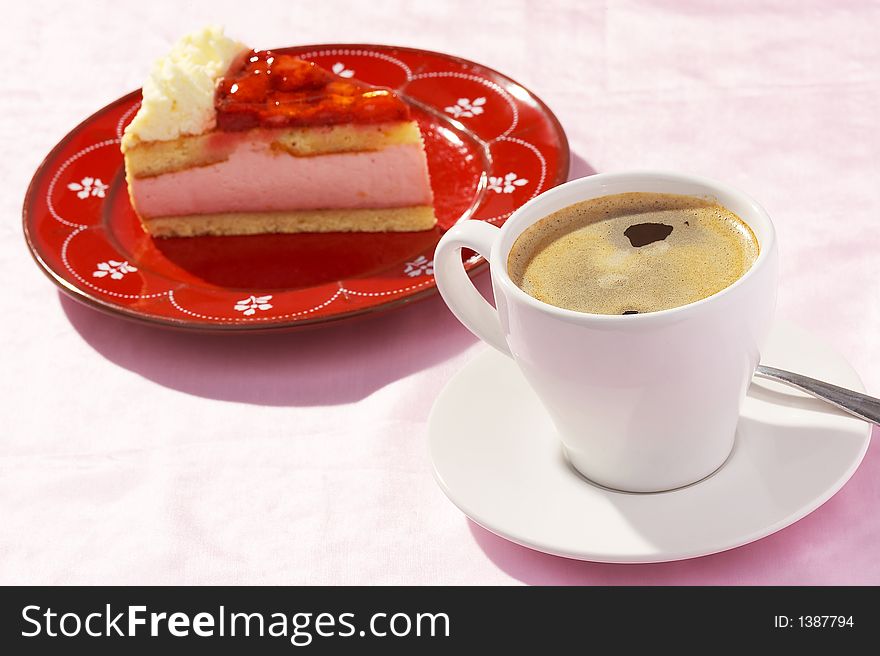 A cup of coffee and one  piece of strawberry cake. A cup of coffee and one  piece of strawberry cake