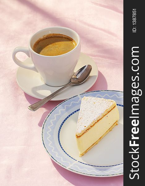 A cup of coffee and a piece of cheese cake. A cup of coffee and a piece of cheese cake