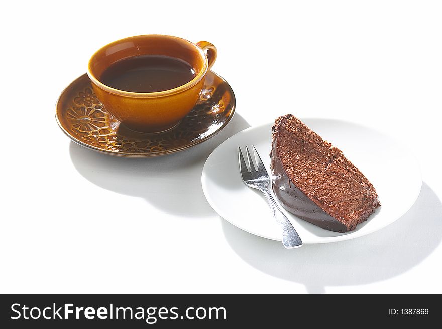 Cup of coffee and piece of chocolate cake on a white background. Cup of coffee and piece of chocolate cake on a white background