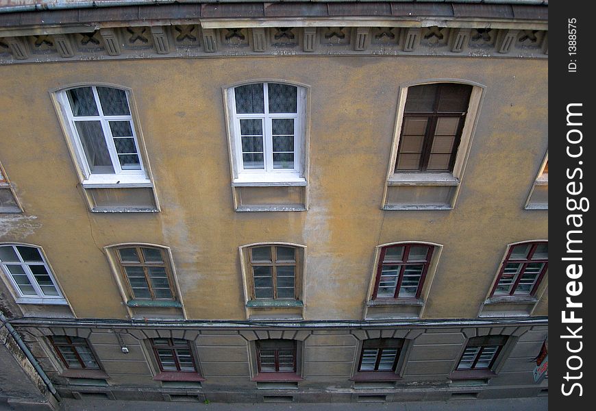 Old rundown buildings in eastern European city, with windows in a descending image