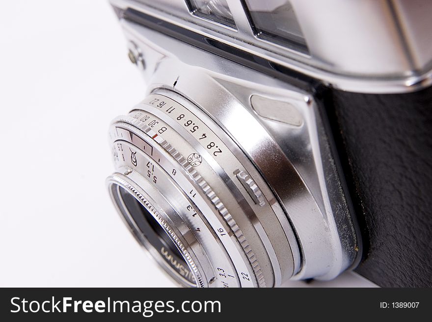 An old 35mm film camera isolated on white. An old 35mm film camera isolated on white