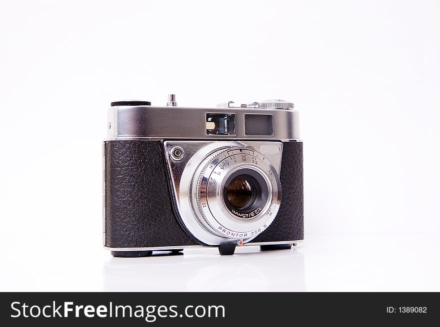 An old 35mm film camera isolated on white. An old 35mm film camera isolated on white