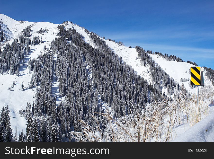 Winter Mountain And Road Sign