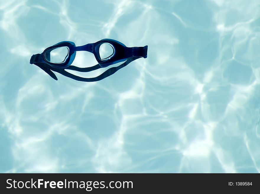 Swimming glasses in a shape of happy face, fun - showing that it is a great activity. Swimming glasses in a shape of happy face, fun - showing that it is a great activity