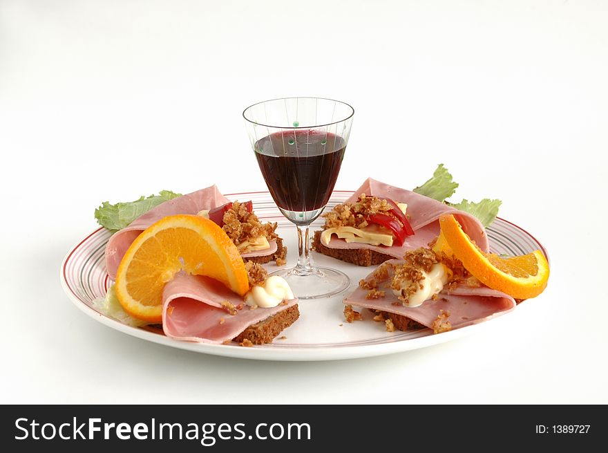 A dish of salami and wine. A dish of salami and wine