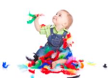 Little Boy Is Sitting On A Flow With Feathers Stock Photo Little Boy Is Sitting On A Flow With Feathers Stock Photo