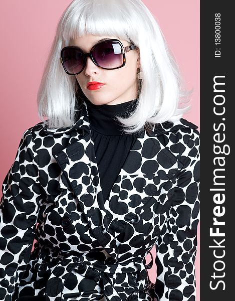 Young fashionista in platinum wig sunglasses and stylish spotted jacket