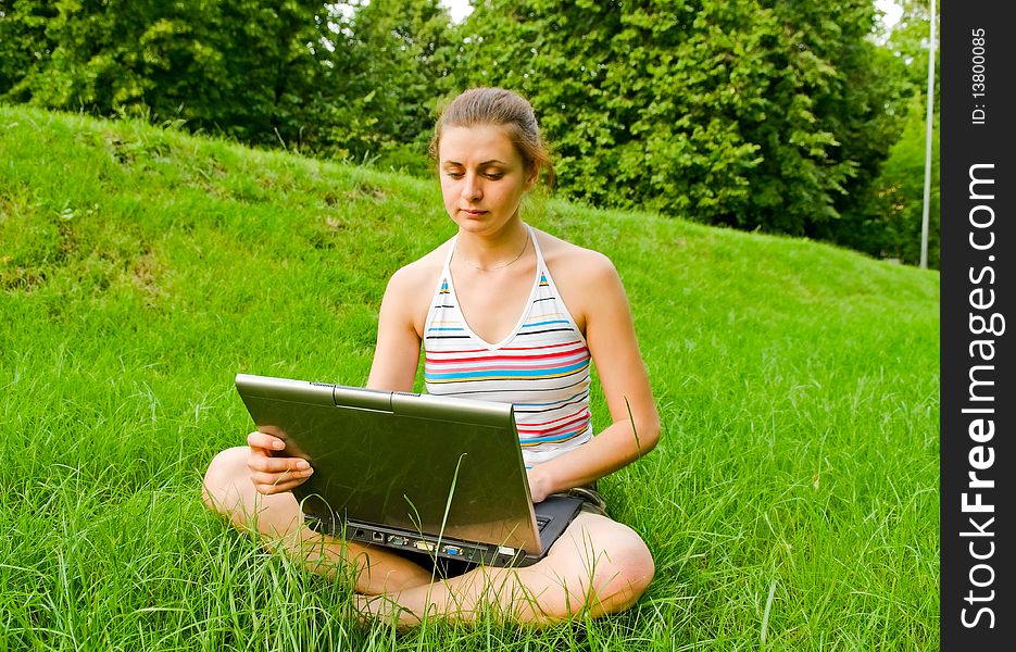 Young woman with notebook in park. Young woman with notebook in park