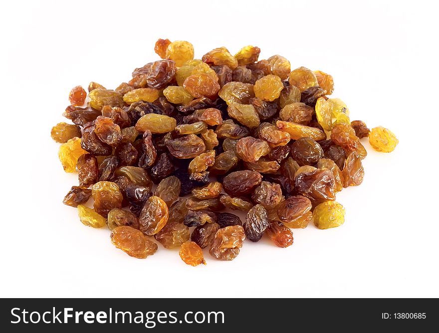 A handful of raisins on a white background