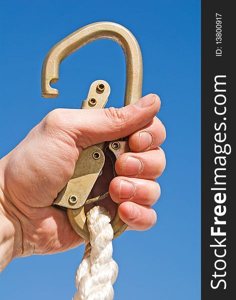 Hand with a carbine in the blue sky