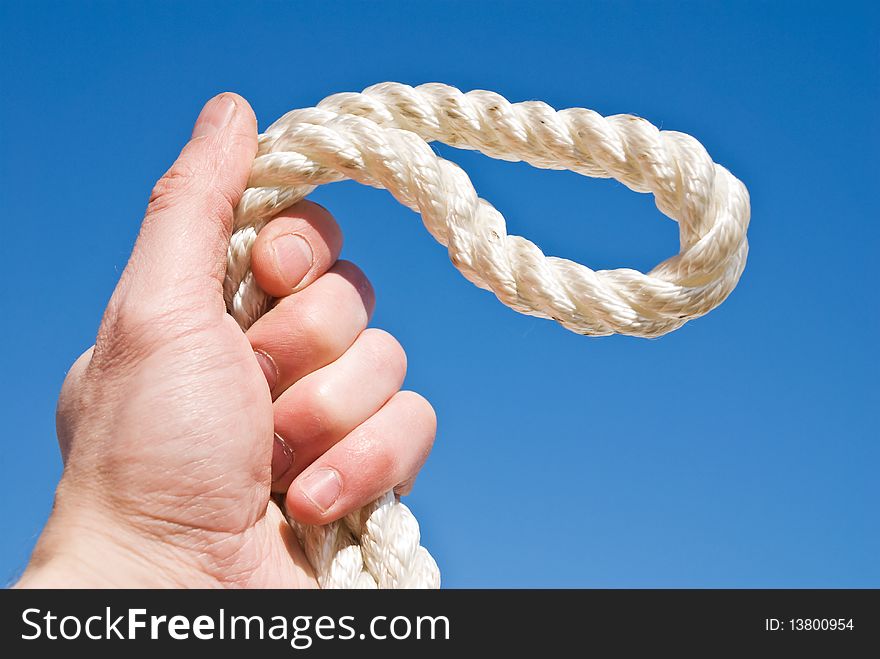 Cord in a hand on a blue background