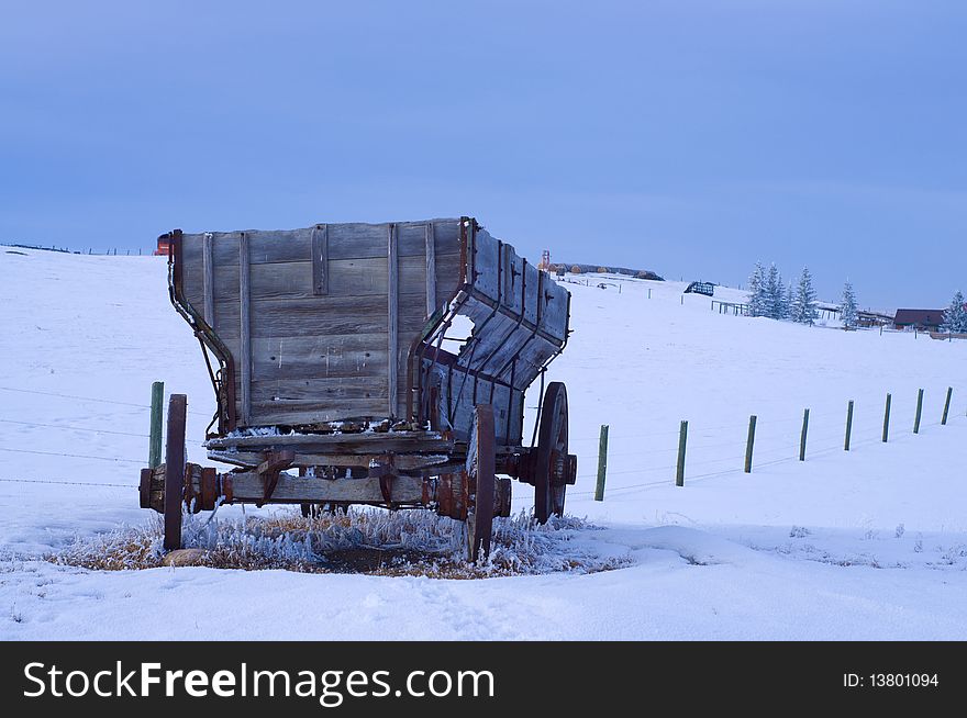 Old Antique Wagon In Snow Covered Field