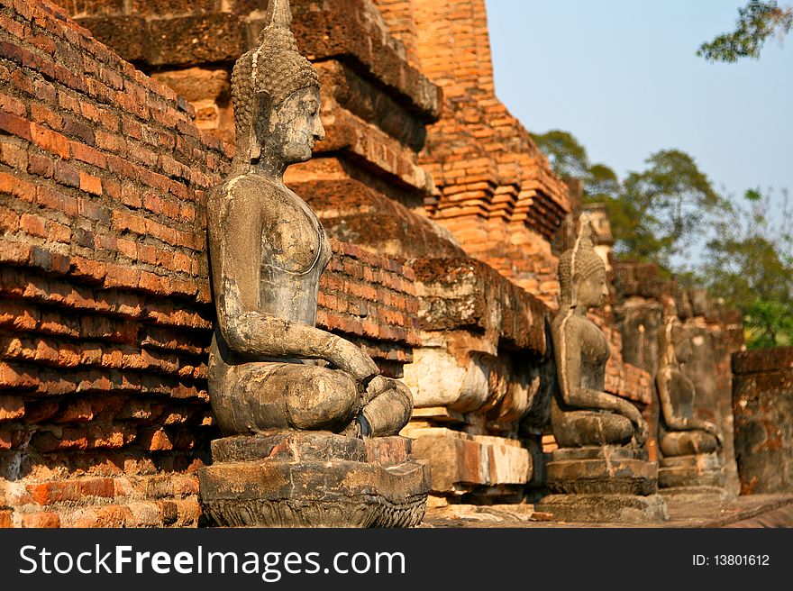 Photo of statue of Buddha in Sukhithai historical park. The statue is a part of ancient Buddhist temple (wat). Photo of statue of Buddha in Sukhithai historical park. The statue is a part of ancient Buddhist temple (wat).