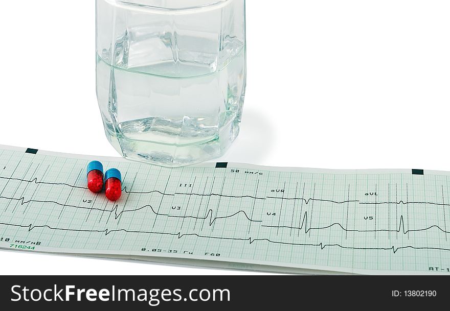 Pill and glass with water over an printout of a electrocardiogram report. Isolated on white with  light shadow. The file includes a clipping path so it is easy to work with. Pill and glass with water over an printout of a electrocardiogram report. Isolated on white with  light shadow. The file includes a clipping path so it is easy to work with.