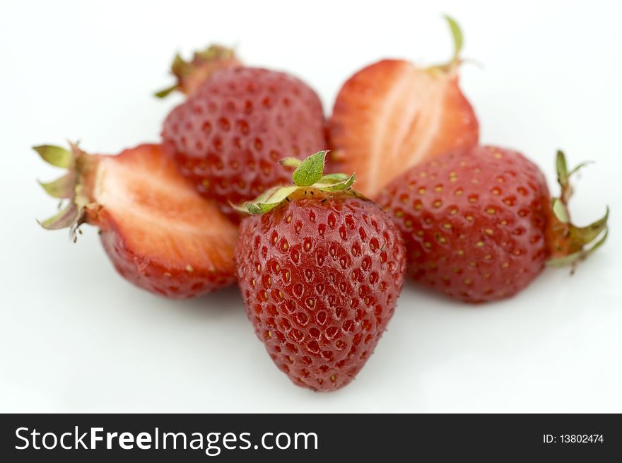 Fresh juicy Strawberries isolated on white. One cup (144 g) of strawberries constitutes approximately 45 calories (188 kJ) and is an excellent source of vitamin C and flavonoids.
