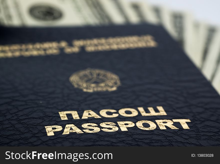 A passport with money, focus is on passport with blur background.