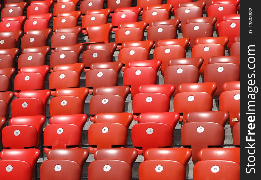 Rows of red folding stadium seats