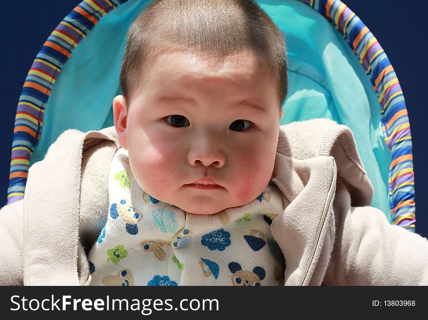 Lovely Chinese baby sitting in the sunshine. Lovely Chinese baby sitting in the sunshine