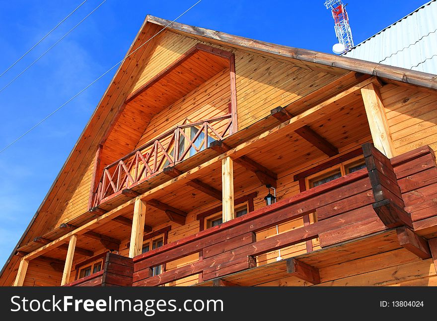 Part of a wooden house against blue sky. Part of a wooden house against blue sky.