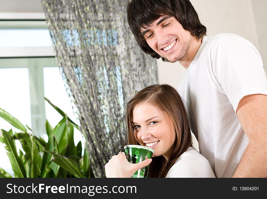 Beautiful girl with green cup and boy. Beautiful girl with green cup and boy